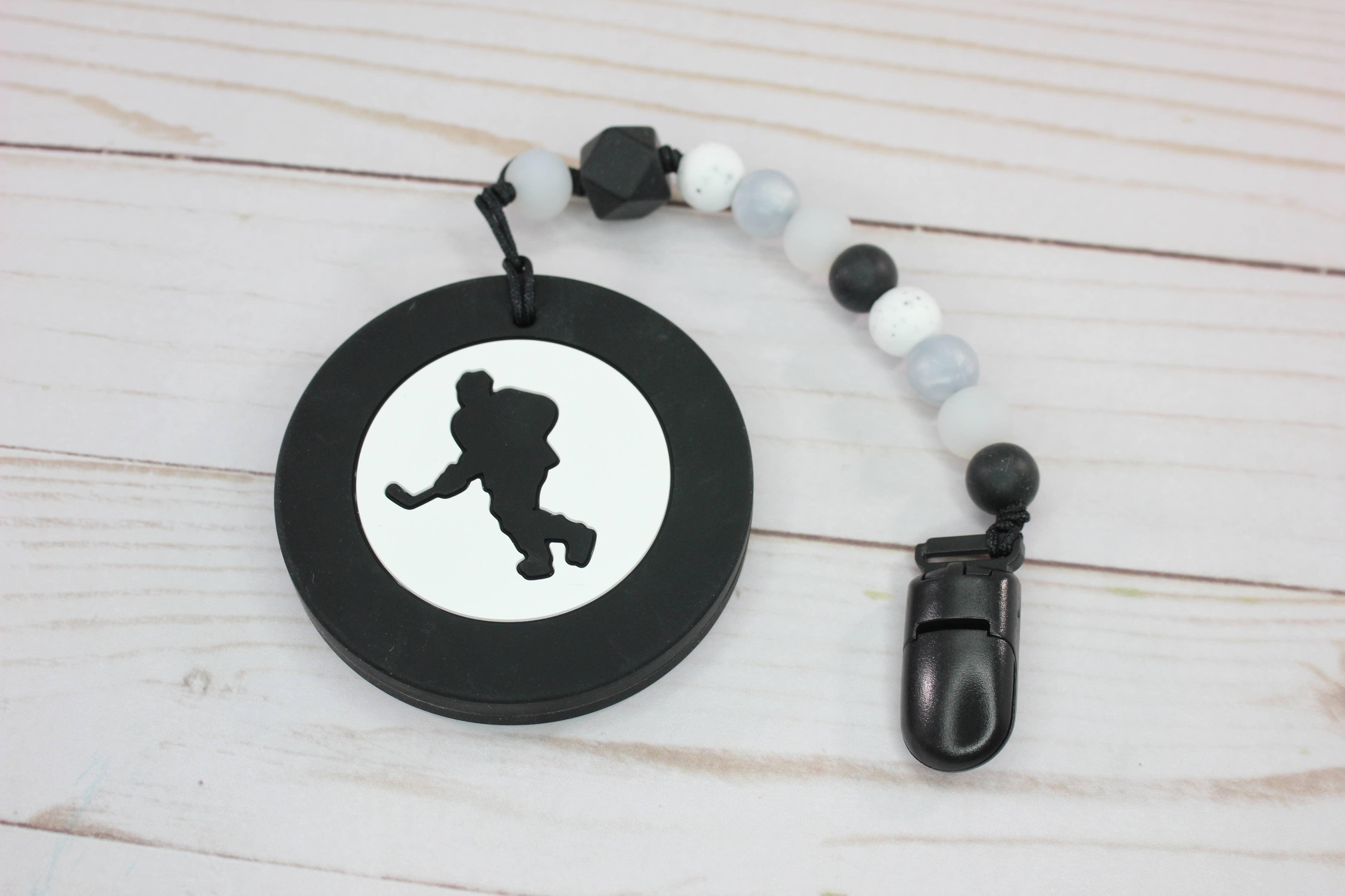 http://theridgekids.com/cdn/shop/products/teether-with-clip-or-hockey-puck-or-baby-boos-teethers-the-ridge-kids.jpg?v=1669748396