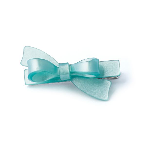 Turquoise bow-shaped hair clip on a white background
