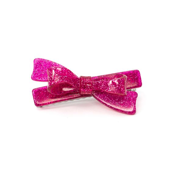 Pink glittery bow hair clip on a white background