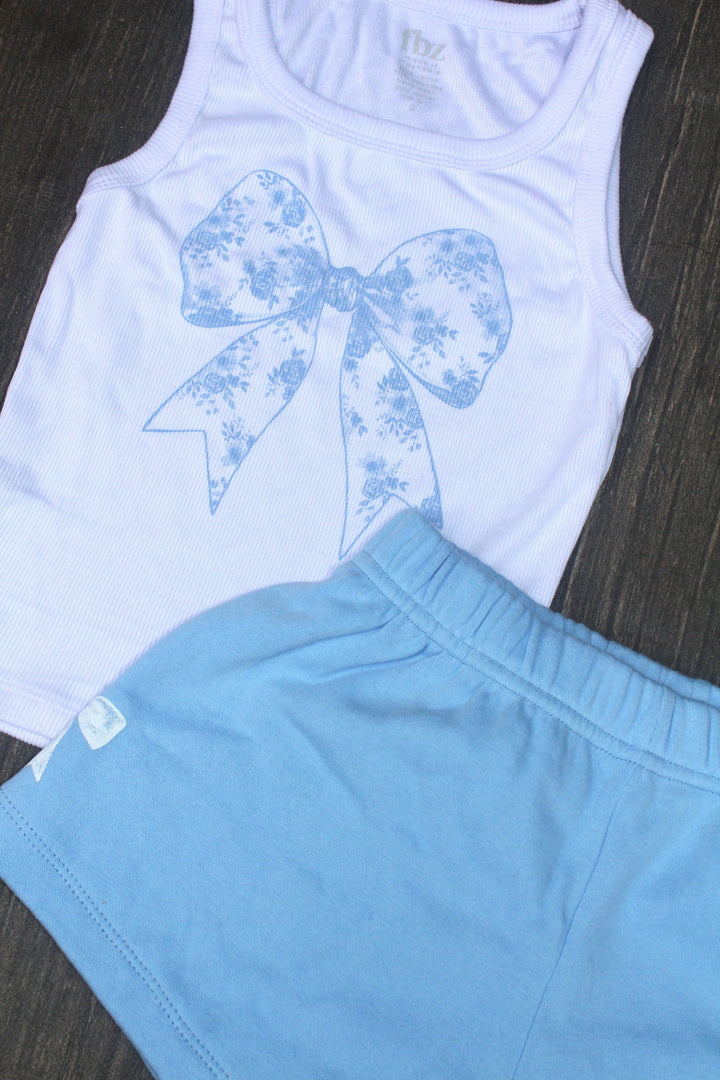 white ribbed tank with blue floral print in the center of the bow paired with baby blue shorts and elastic waist. 