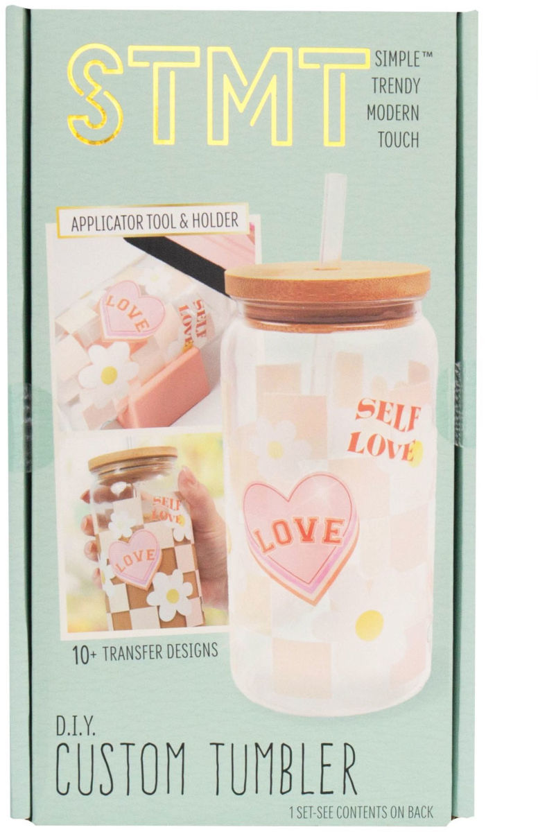STMT DIY Custom Tumbler kit packaging with a tumbler and applicator tool on a light green background.