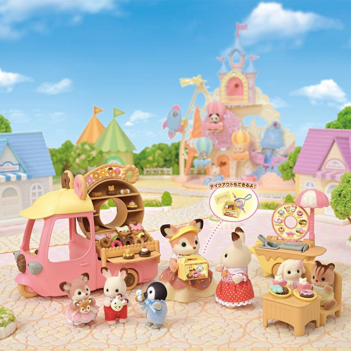 this picture depicts a scene where the calico critters are buying donuts from the stand and enjoying one another's company