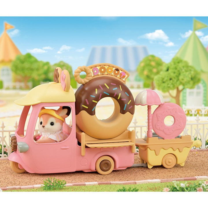 this picture depict a small deer driving the donut truck in a the calico critter town