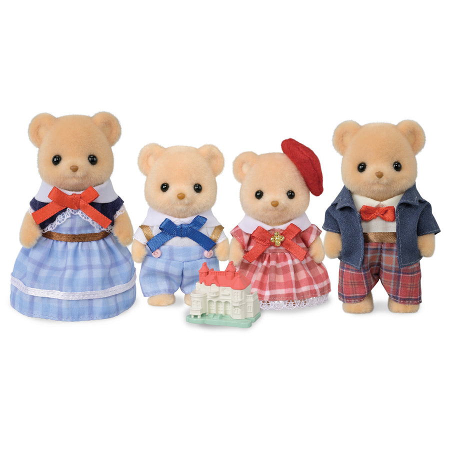 Four teddy bear toys with a cake on a white background