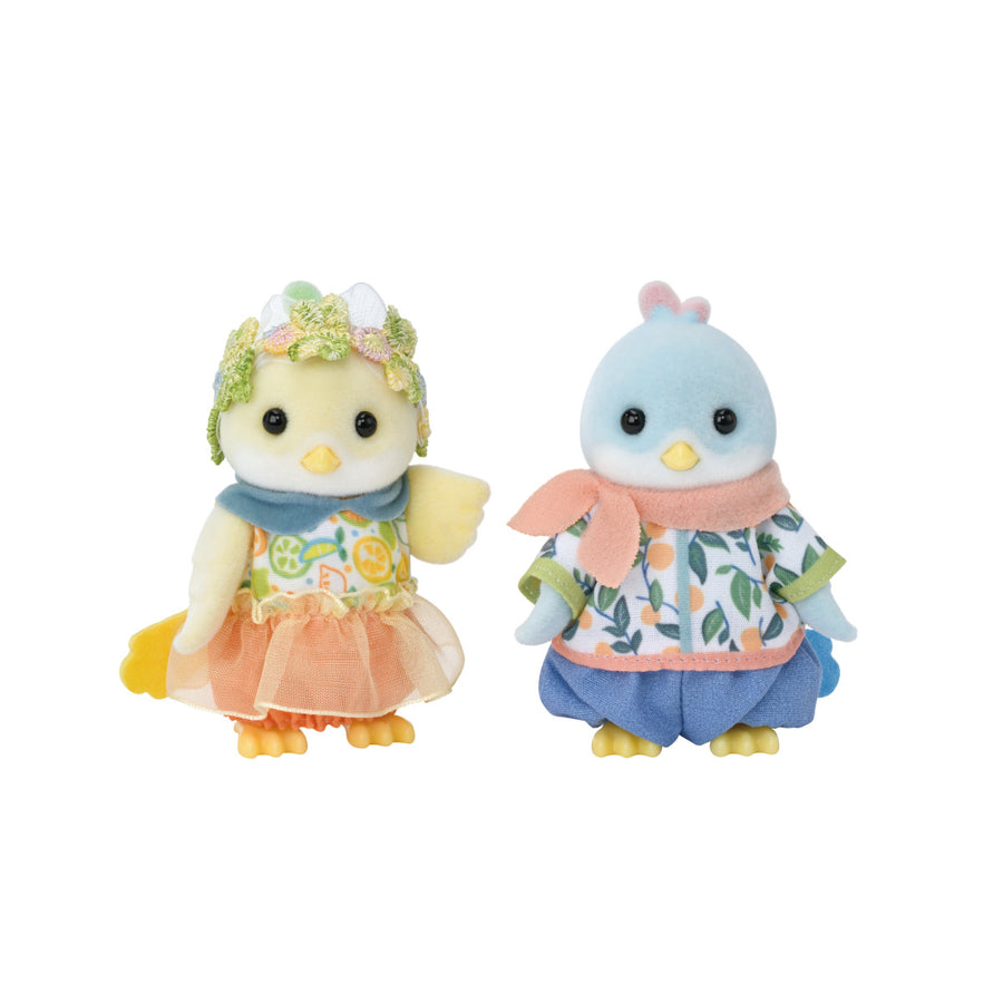 Two small bird figurines wearing colorful outfits on a white background