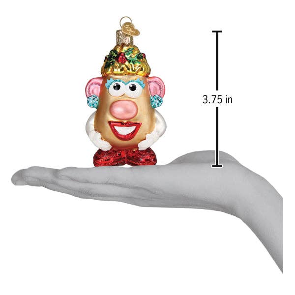 Decorative ornament shaped like a character with a crown, held in a hand to show size.