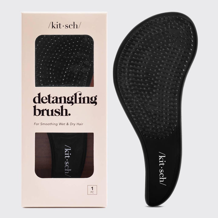 sleek black detangling brish with flexible bristles and curved design