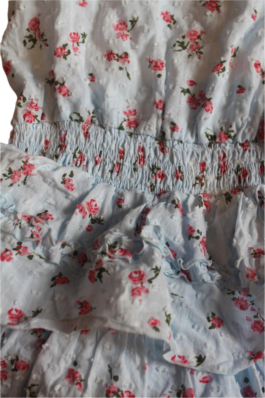 close up of the fabric with the texture, color and tiny pink roses. 