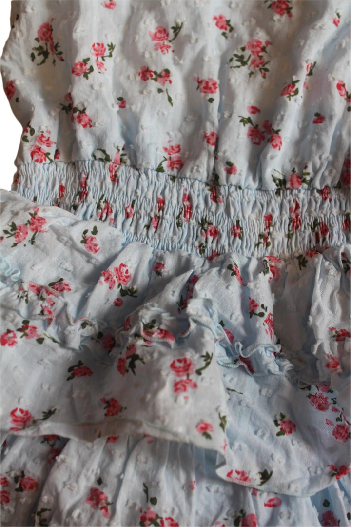 close up of the fabric with the texture, color and tiny pink roses. 