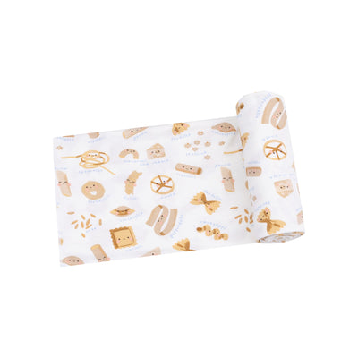 baby swaddle blanket with all different kinds of pasta all over it. 