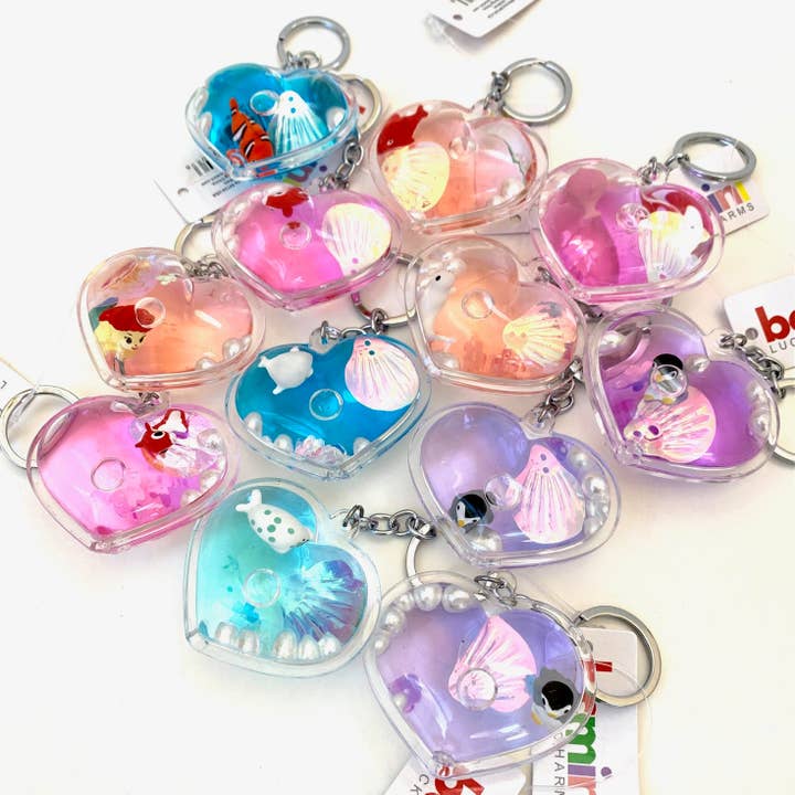 heart shaped keychains with a sealife creature and shell inside. 