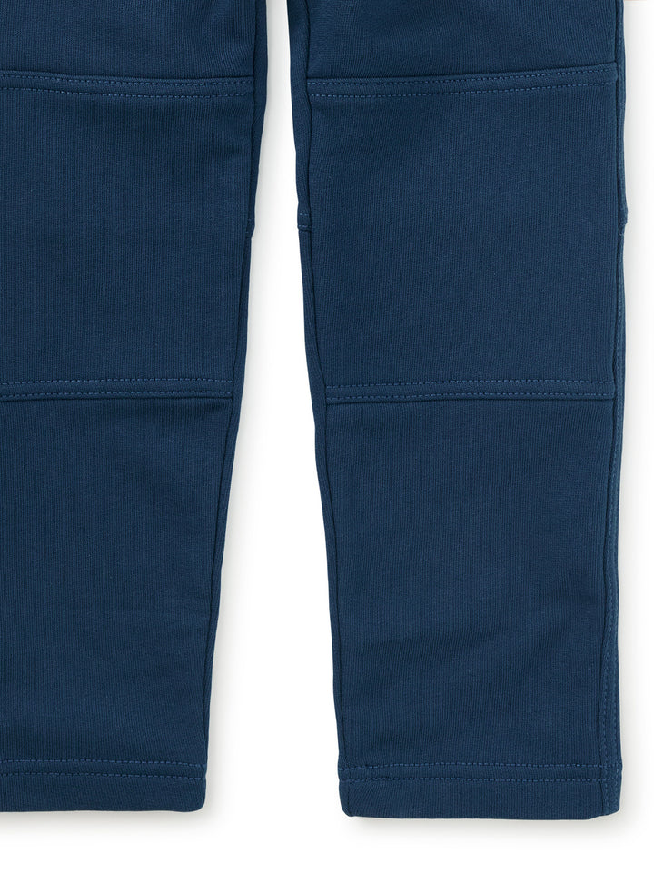 Close-up of the reinforcement of the knee on the blue pants . 