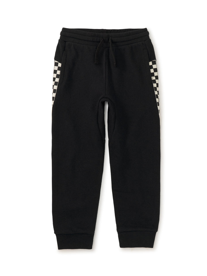 Black sweatpants with checkered side panels on a white background
