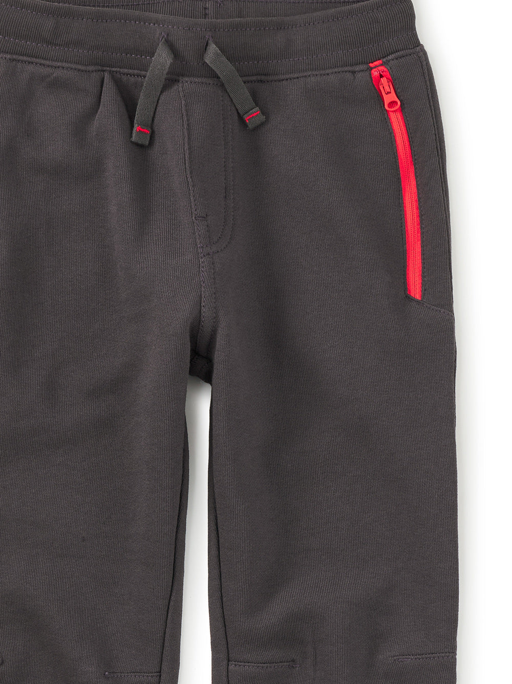 Dark gray pants with a red zipper on a white background
