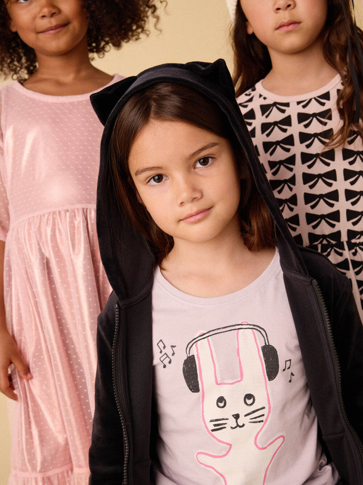little girl wearing the graphic tee with the bunny on the front. 