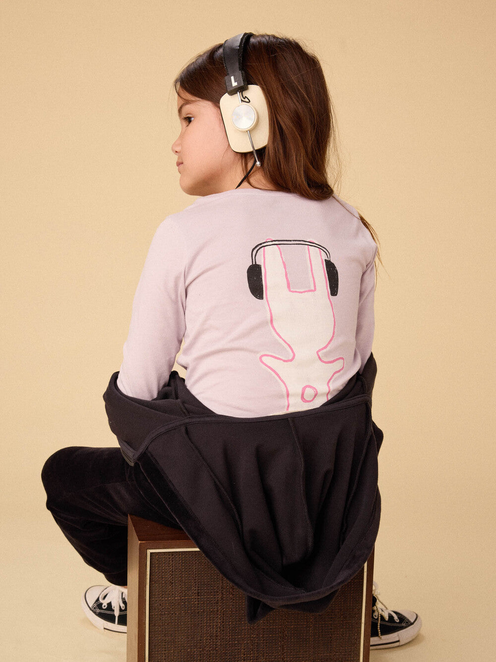 back of t-shirt shows the back of the bunny wearing headphones 