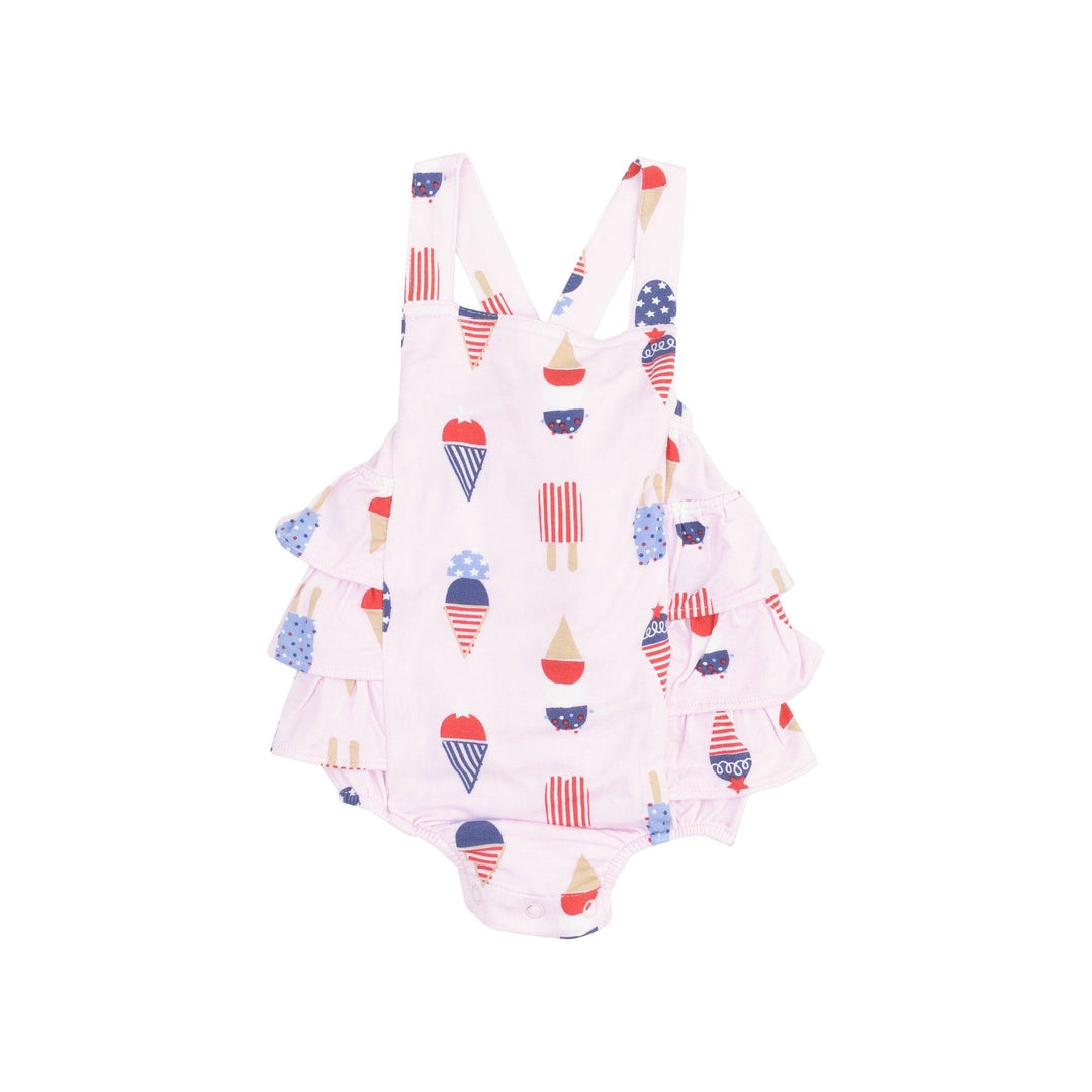 pale pink ruffle sunsuit with ruffles in the back, criss cross straps . american flag printed ice cream cones all over the sunsuit. 