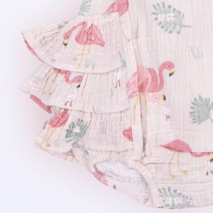 Floral baby romper with pink flamingo design on a white background