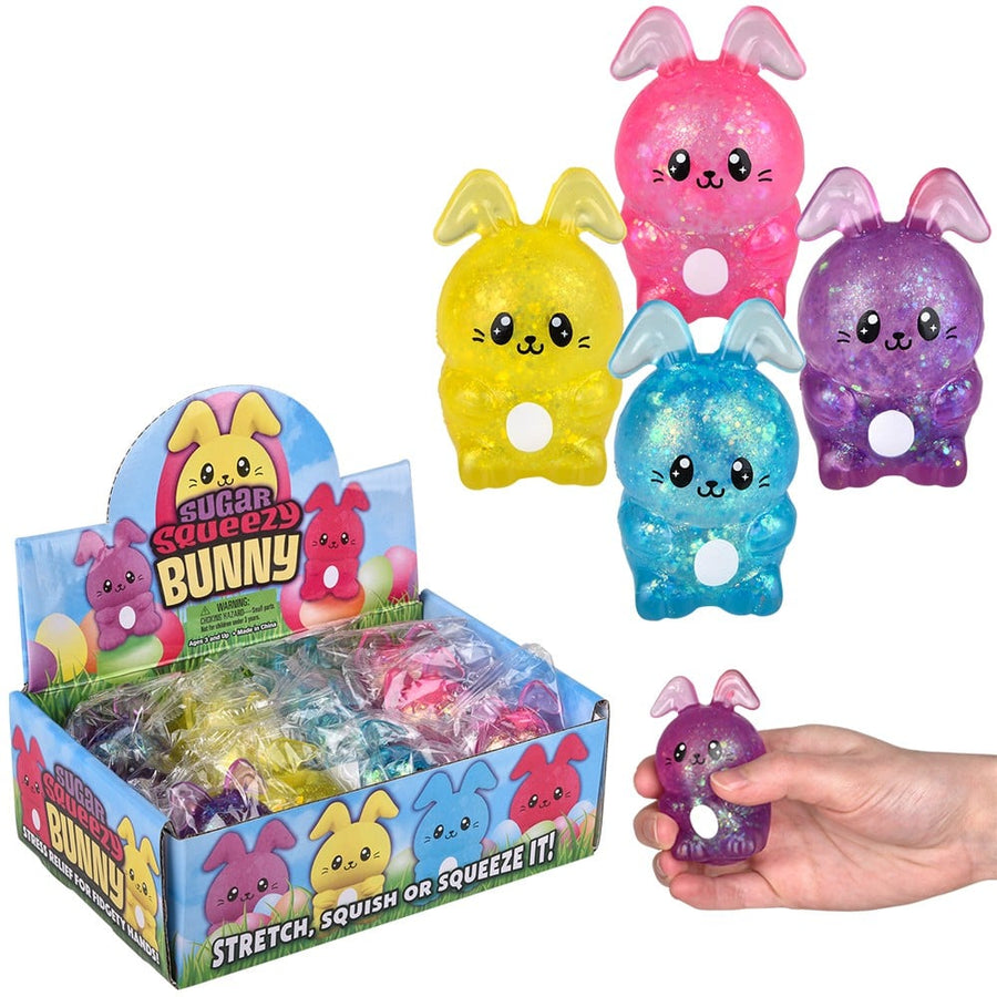Colorful bunny-shaped squishy toys with packaging and a hand holding one toy.
