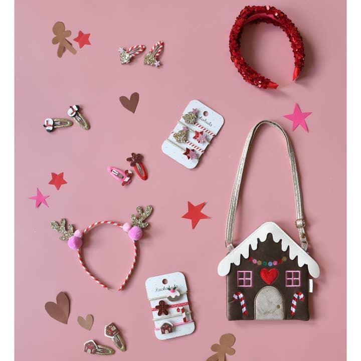 this is a holiday set of accessories with gingerbread house crossbody bag, reindeer headband and Christmas accessories