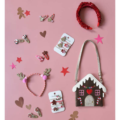 this is a holiday set of accessories with gingerbread house crossbody bag, reindeer headband and Christmas accessories