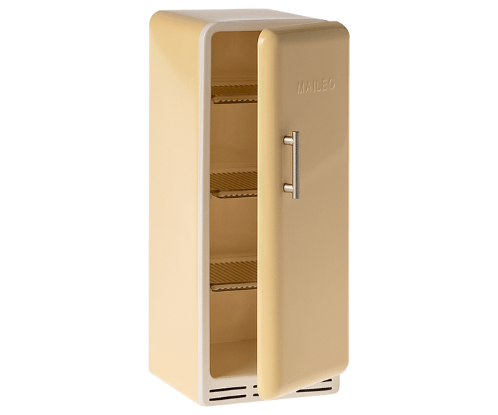 vintage inspired yellow refrigerator with the door slightly ajar with metal shelves inside