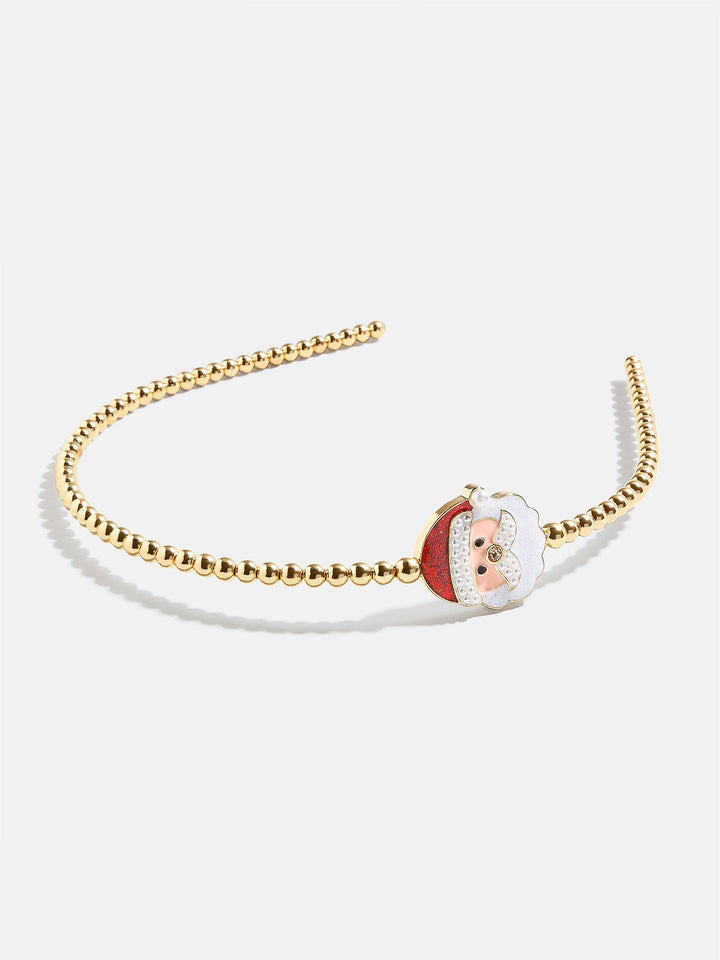 Gold headband with a Santa Claus charm on a white background