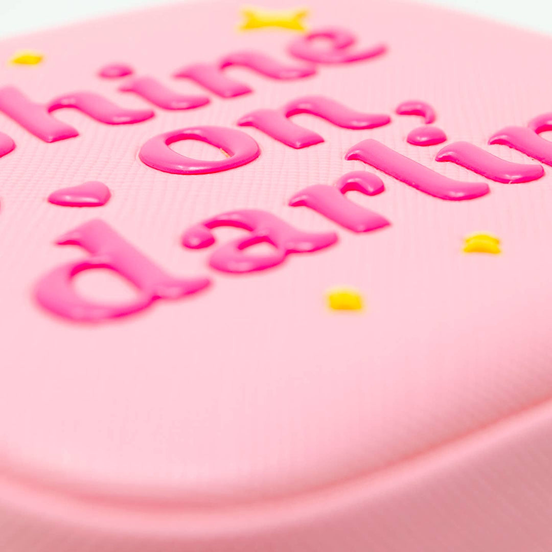 close up of the material and embossed lettering with 'shine on darling' text and colorful dots
