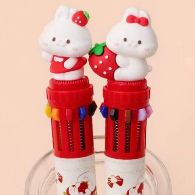 retractable pen with 10 different color options. red and white pen with  small white bunnies on the top, one wearing a strawberry and the other holding one. 