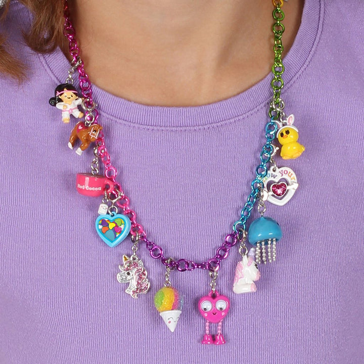 Colorful necklace with various charms on a purple shirt