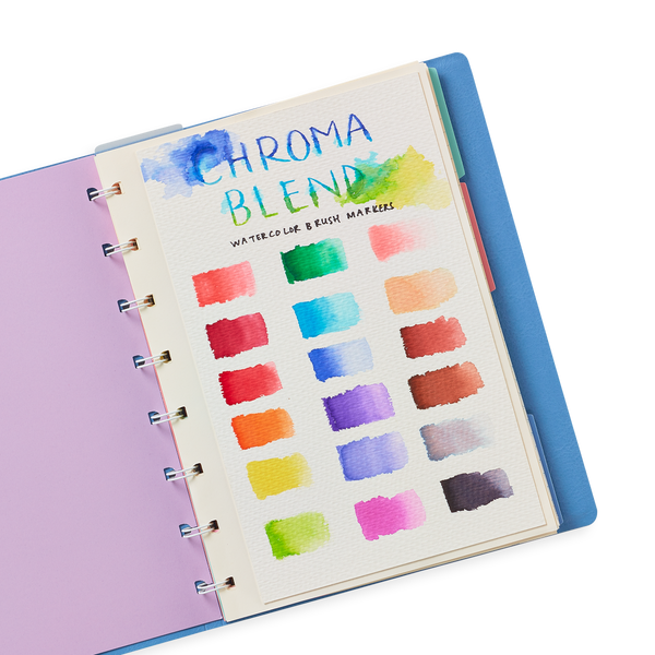 Open notebook with watercolor swatches on a white background