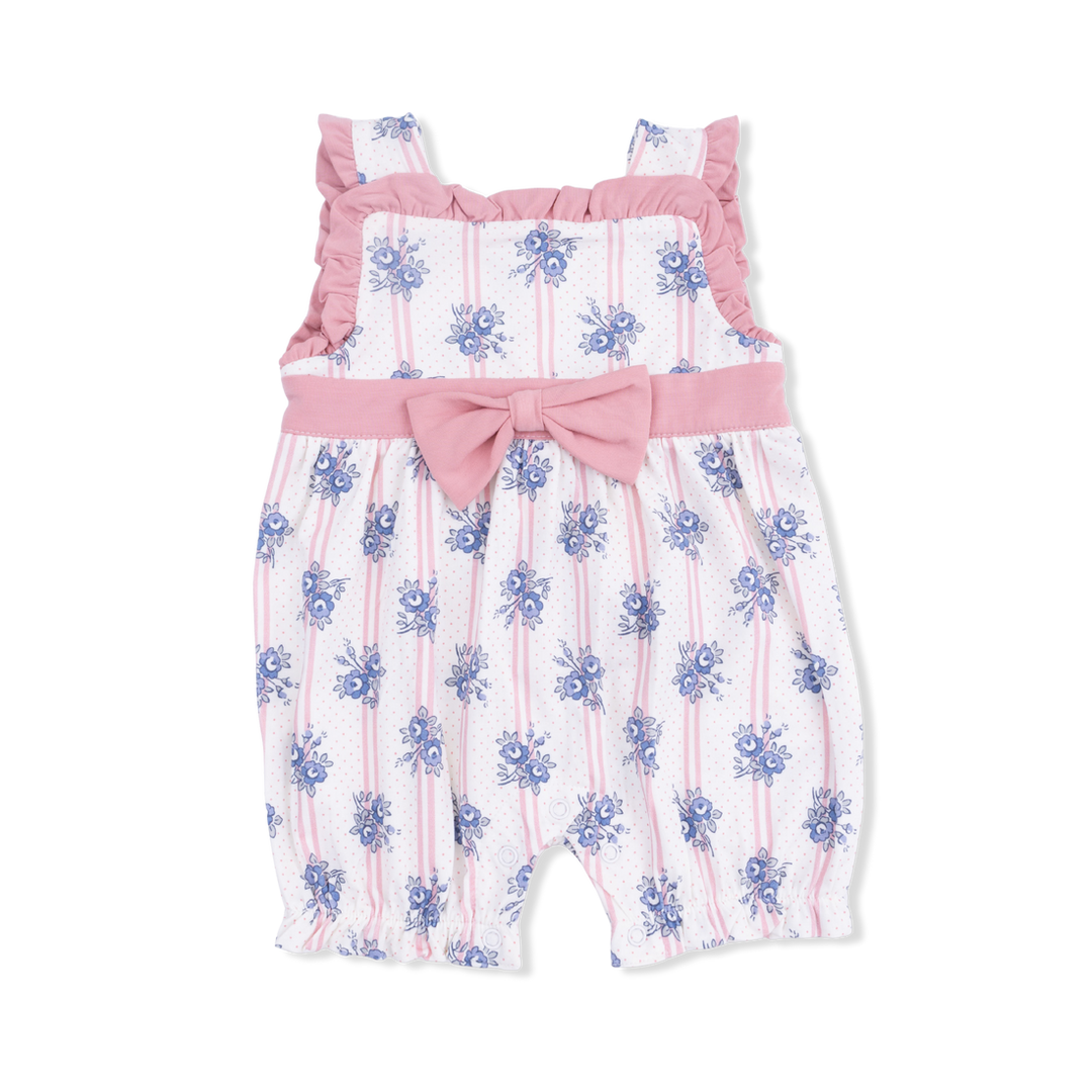 Baby romper with floral pattern and pink bow on a white background