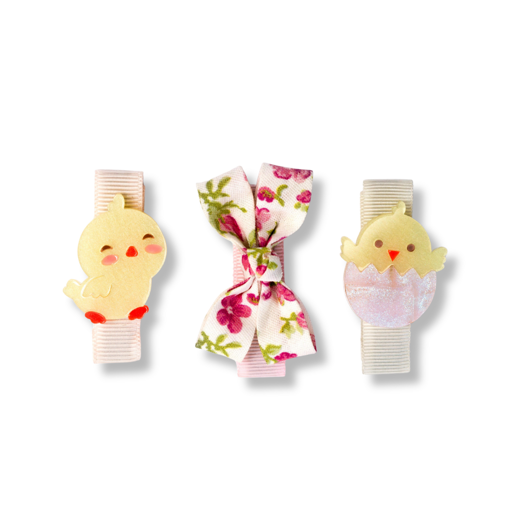 Three decorative clips with chick designs on a white background