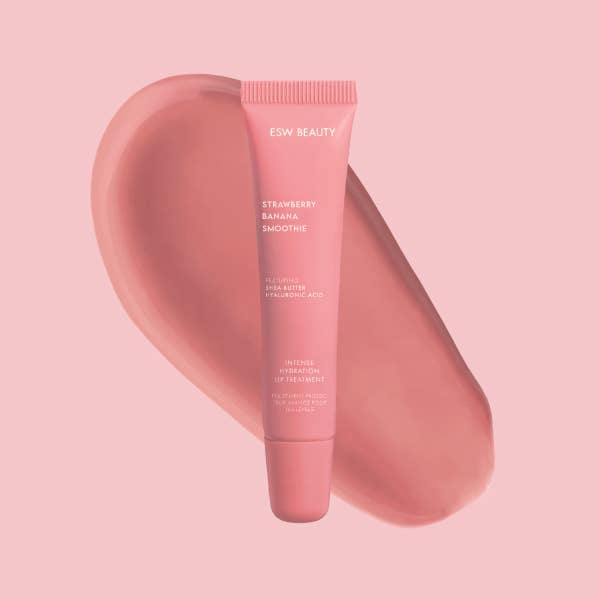 Pink lip balm tube labeled 'ESW Beauty' on a pink background