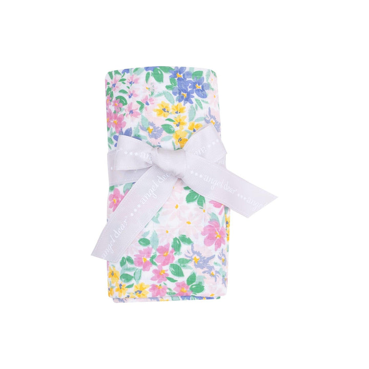 this picture shows the emma floral swaddle rolled up the way it is sold to the customer. 
