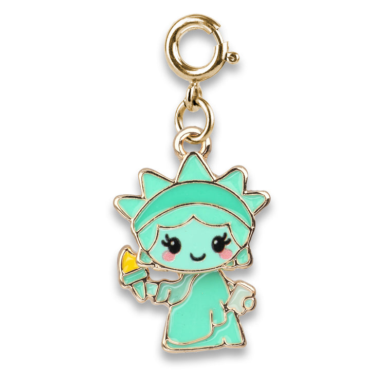 Charm resembling a stylized statue of liberty, gold accents on a white background