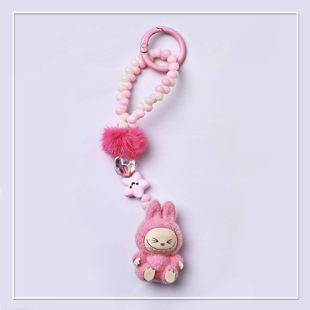 Pink plush labubu toy keychain with beads and decorative elements 