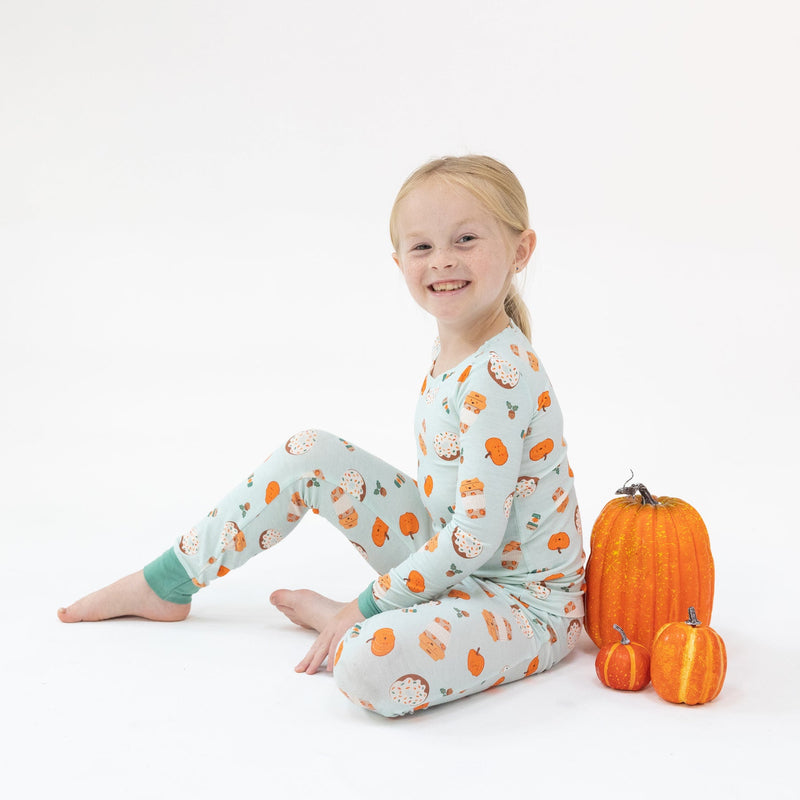 Little girl modeling pumpkin spice latte pajamas.  