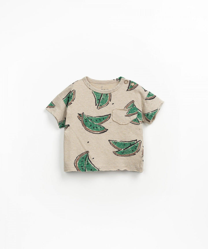 beige t-shirt with green watermelon pieces. 