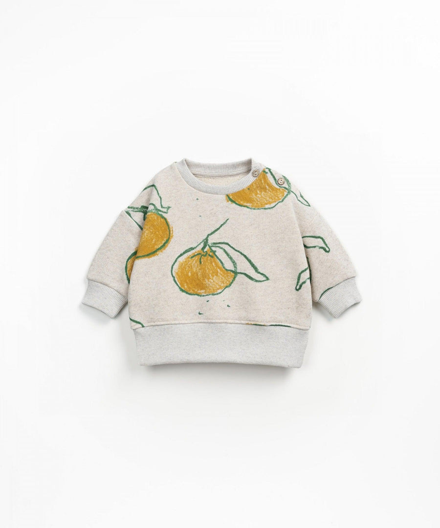 heathered biege sweatshirt with big oranges and green banana leaves attached to the fruit. long sleeves 