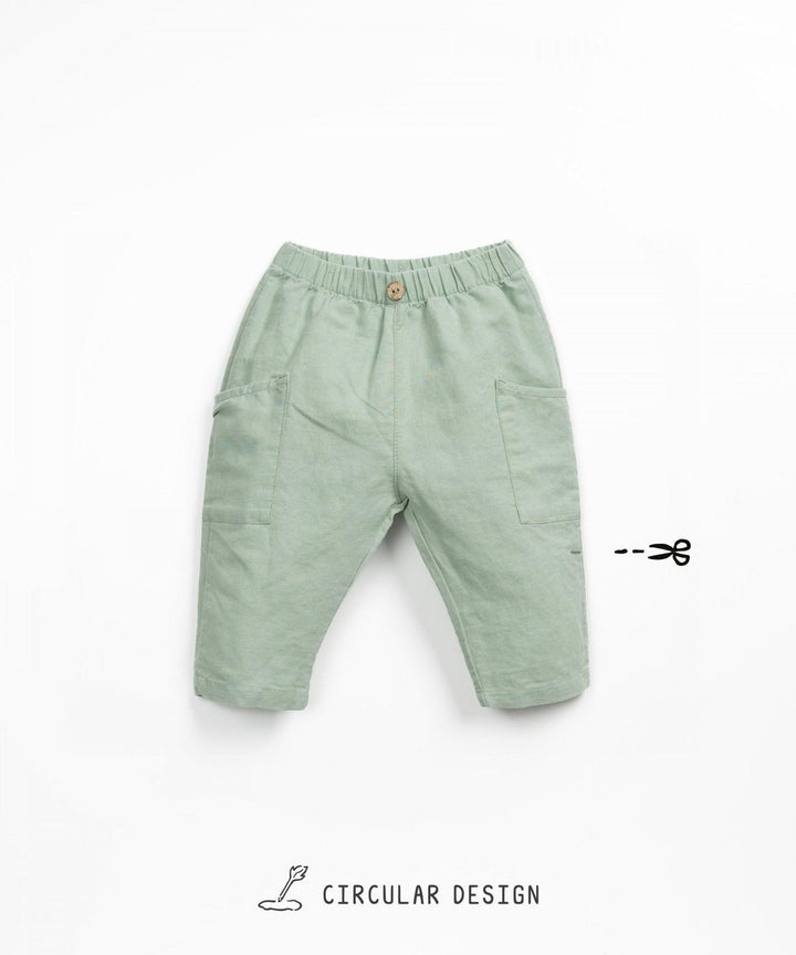 green linen baby boy trousers with pockets on the side and button at the waist band. 