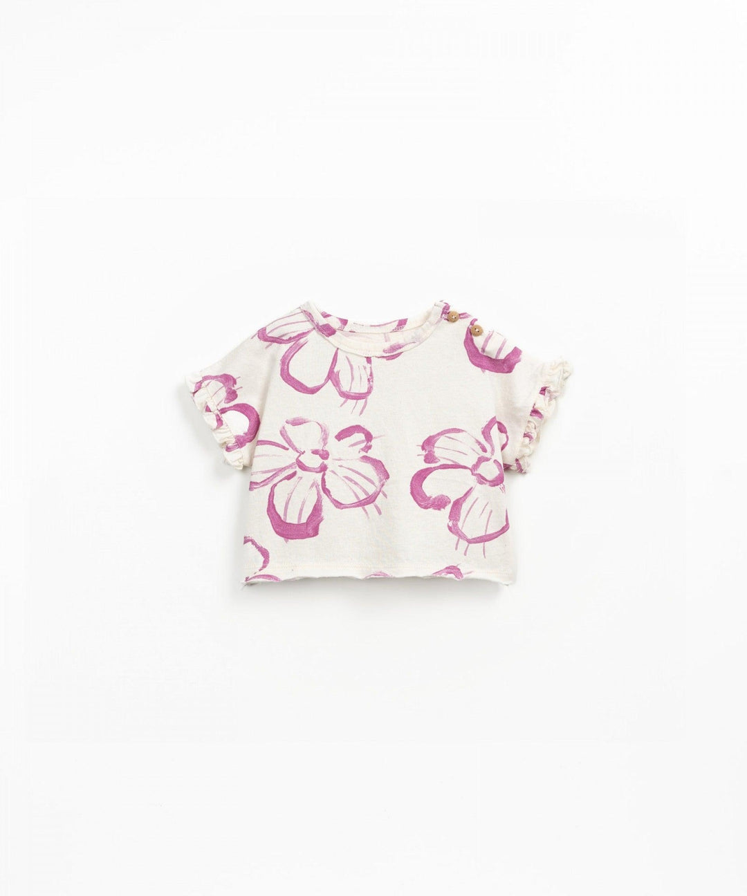 ivory cotton tee with ruffle edges on sleevces. big pink flowers on the top. 