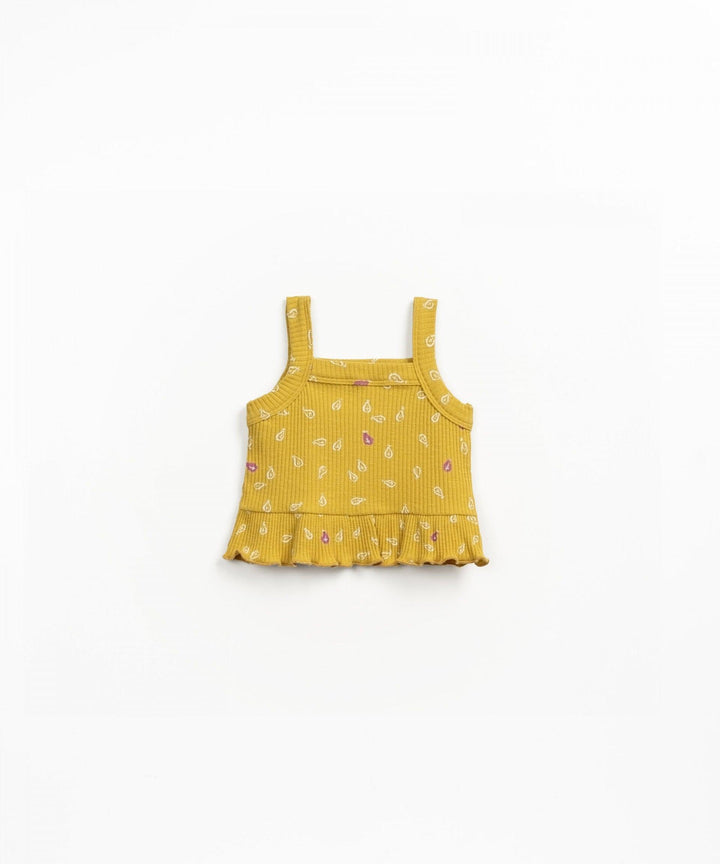 vibrant mustard color, sleeveless with ruffle bottom and spaghetti straps. ribbed cotton fabric with small leaf print. 