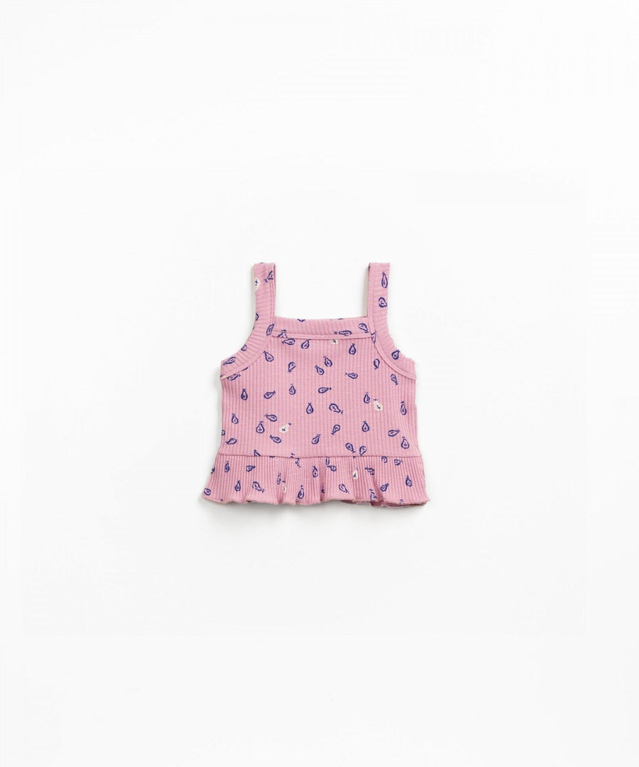 ribbed pink baby top with vibrant blue leaf pattern on it. slight ruffle at the bottom. 