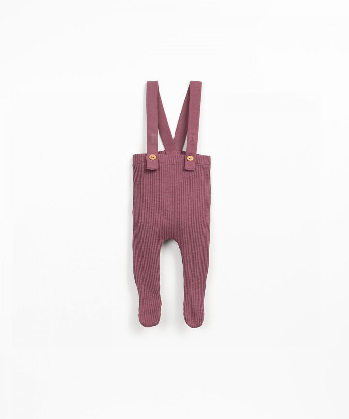 Pink ribbed baby romper with suspenders on a white background