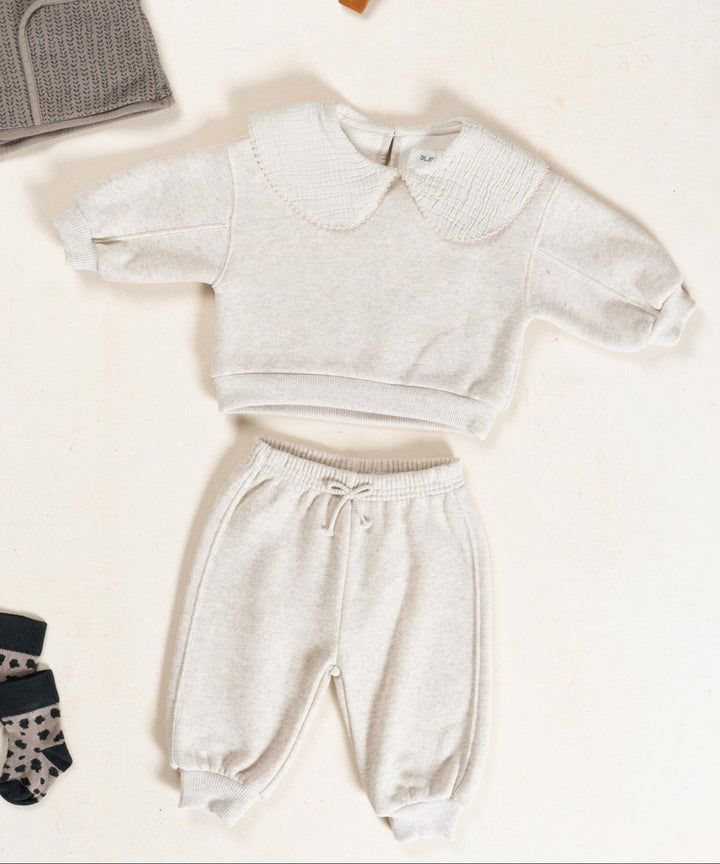 Children's clothing set with a sweater, pants, and socks on a white background