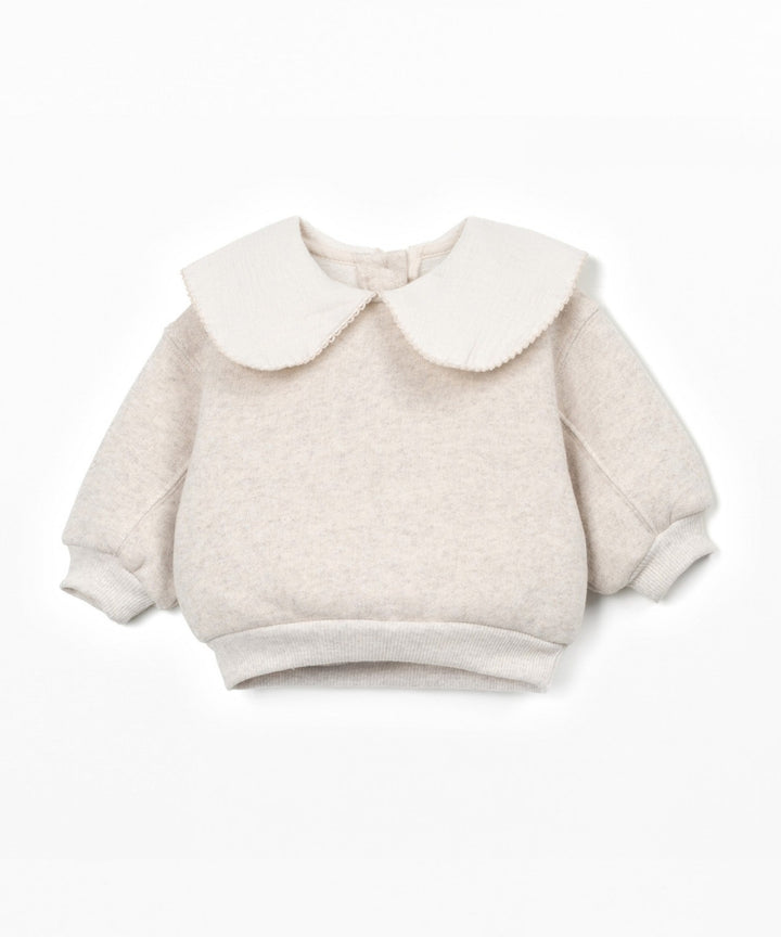 Beige sweater with a large white collar on a white background