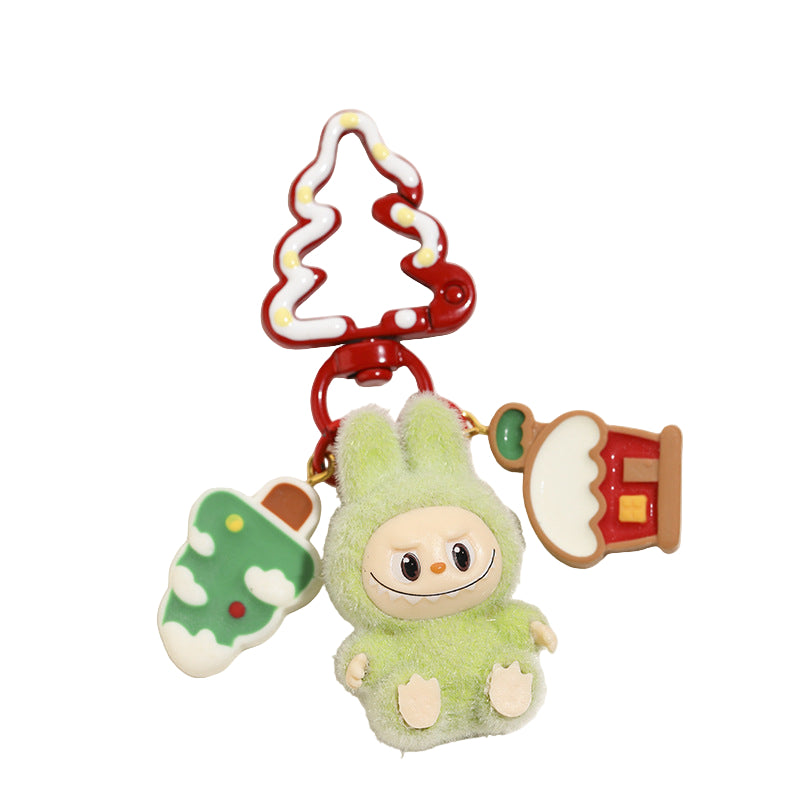 Keychain with a plush character and Christmas-themed decorations on a white surface