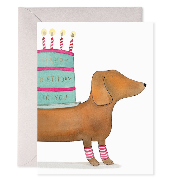 Birthday card with dachshund holding a birthday cake and candles
