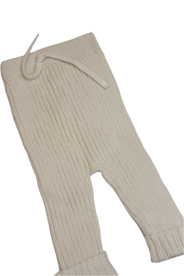 knit baby pants in creme color with small cuff at the bottom of the pants. tie at the waist. 